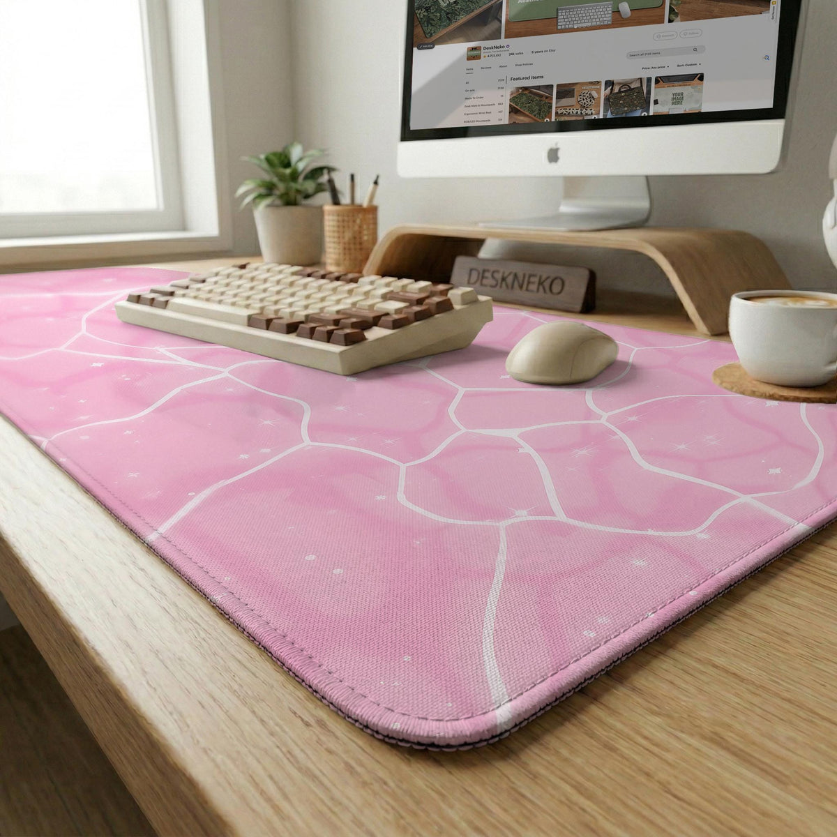 Pastel pink desk mat with a marble-style design, white flowing lines, and small sparkle accents.