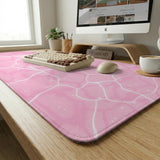 Pastel pink desk mat with a marble-style design, white flowing lines, and small sparkle accents.