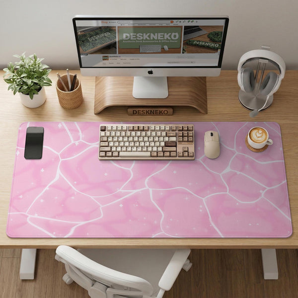 Pastel pink desk mat with a marble-style design, white flowing lines, and small sparkle accents.