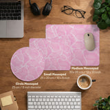 Pastel pink desk mat with a marble-style design, white flowing lines, and small sparkle accents.