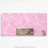 Pastel pink desk mat with a marble-style design, white flowing lines, and small sparkle accents.