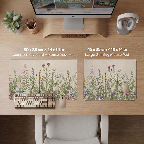 A desk mat with a botanical meadow design featuring wildflowers, leafy stems, and soft neutral colors.