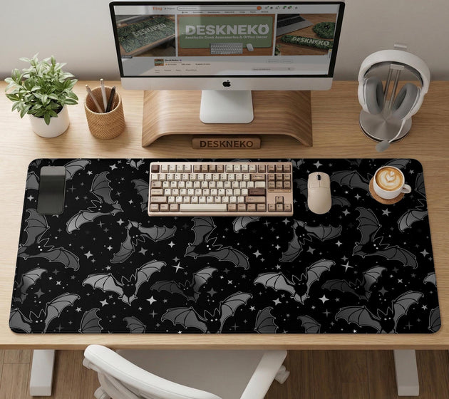 Black desk mat with a dark bat pattern and scattered stars on a charcoal background.