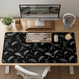 Black desk mat with a dark bat pattern and scattered stars on a charcoal background.