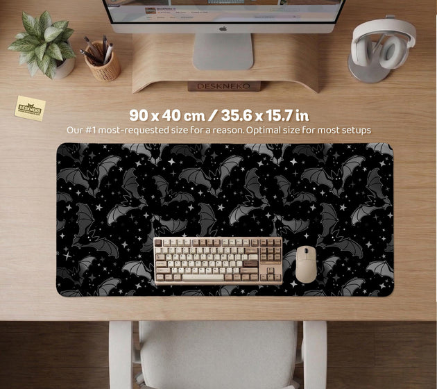 Black desk mat with a dark bat pattern and scattered stars on a charcoal background.