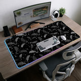 Black desk mat with a dark bat pattern and scattered stars on a charcoal background.