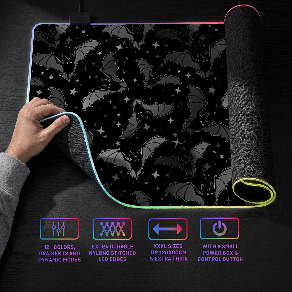 Black desk mat with a dark bat pattern and scattered stars on a charcoal background.