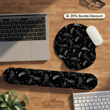Black desk mat with a dark bat pattern and scattered stars on a charcoal background.