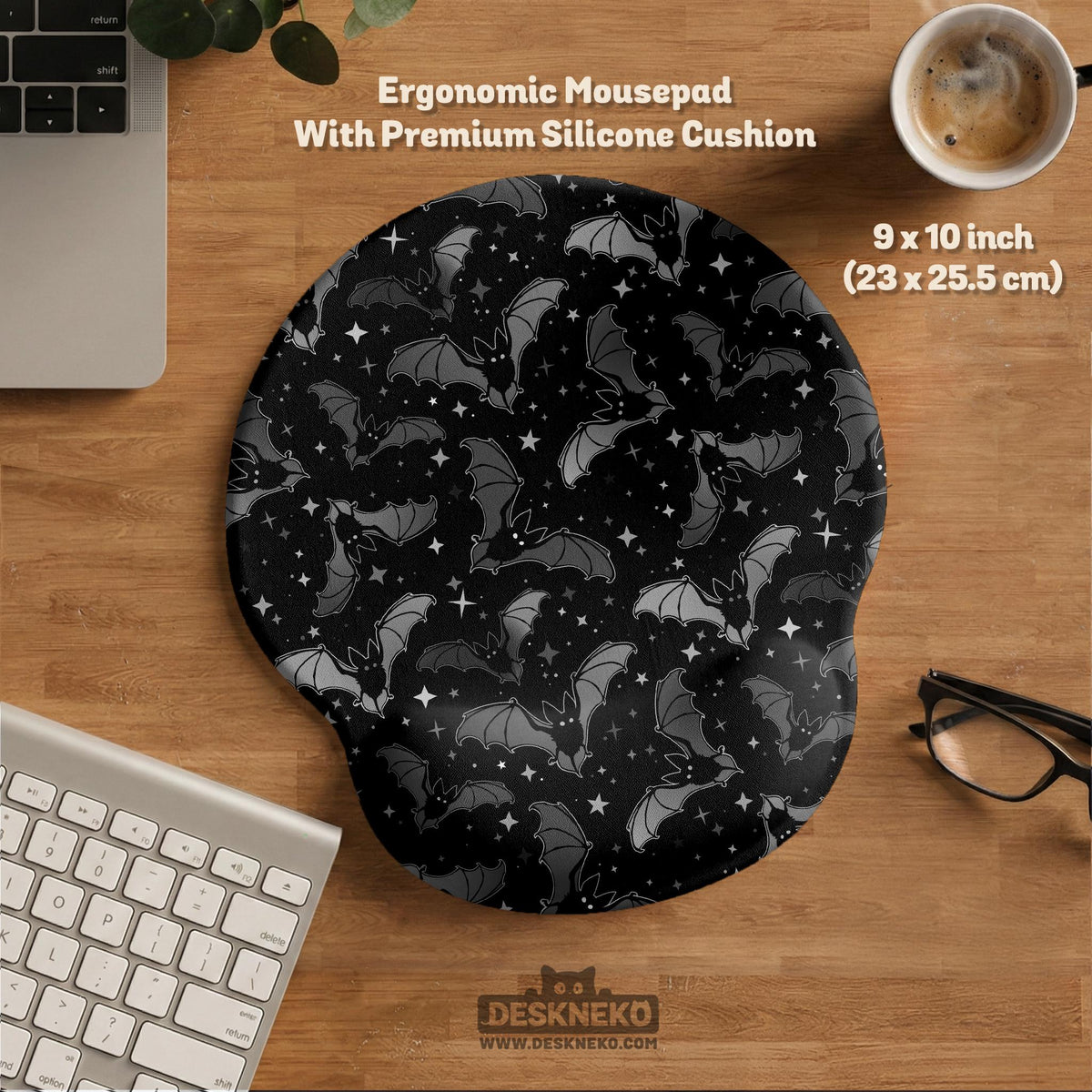 Black desk mat with a dark bat pattern and scattered stars on a charcoal background.