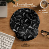 Black desk mat with a dark bat pattern and scattered stars on a charcoal background.