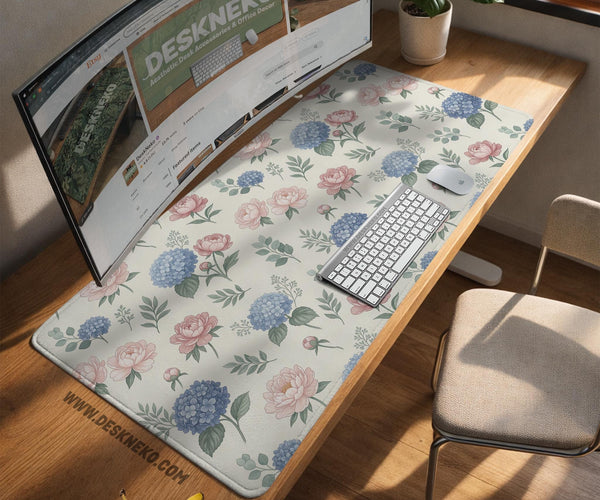 Floral desk mat with sage greenery, pink peonies, blue flowers, and a warm cream background.