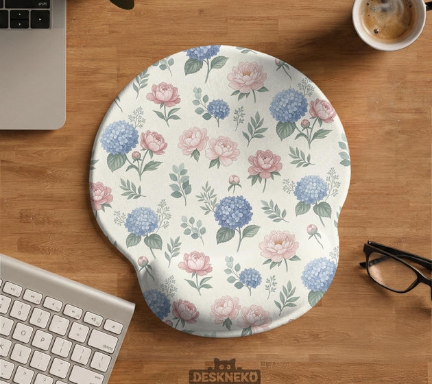 Mousepad and keyboard wrist rest with a floral print of blue hydrangeas, pink peonies, sage leaves, and a cream background.