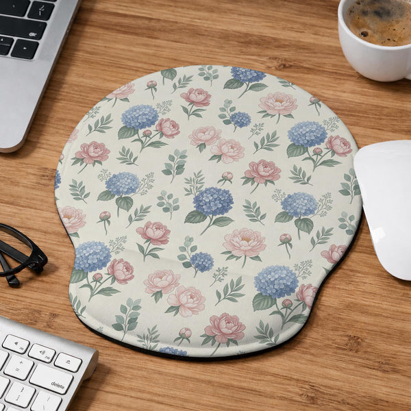 Mousepad and keyboard wrist rest with a floral print of blue hydrangeas, pink peonies, sage leaves, and a cream background.