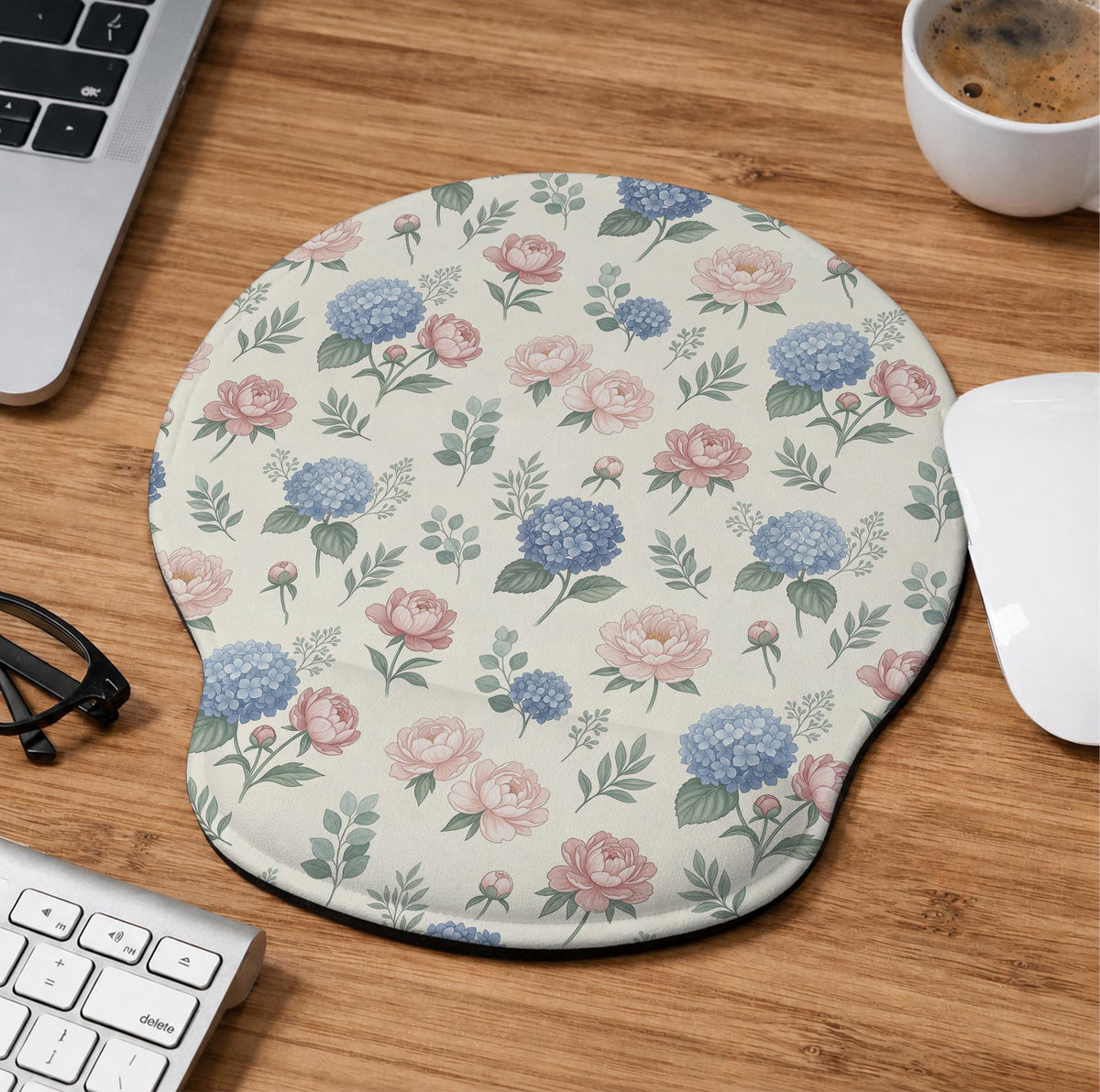 Mousepad and keyboard wrist rest with a floral print of blue hydrangeas, pink peonies, sage leaves, and a cream background.