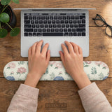 Mousepad and keyboard wrist rest with a floral print of blue hydrangeas, pink peonies, sage leaves, and a cream background.
