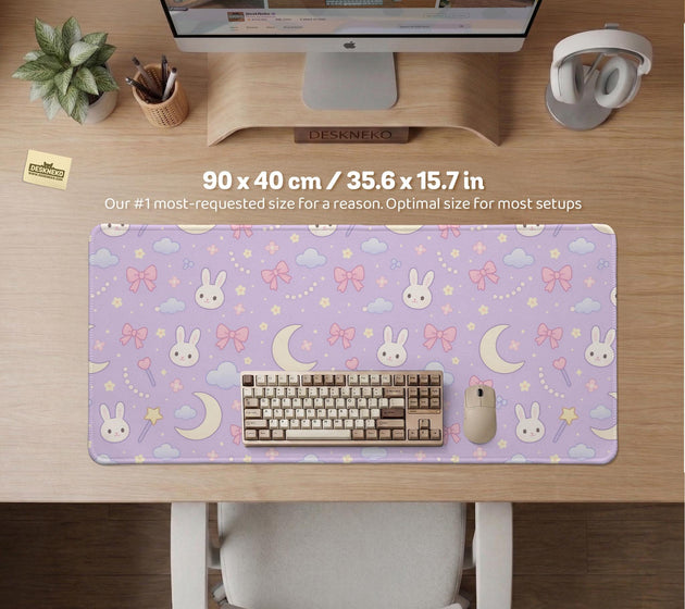 Lavender desk mat with an all-over pattern of bunny faces, clouds, moons, bows, and flowers in pastel colors.