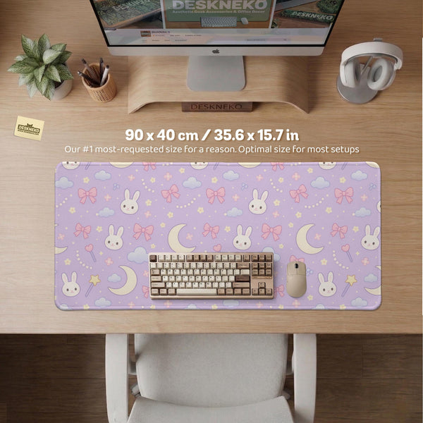 Lavender desk mat with an all-over pattern of bunny faces, clouds, moons, bows, and flowers in pastel colors.