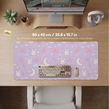 Pastel lavender desk mat with an all-over pattern of bunnies, crescent moons, clouds, bows, stars, and small flowers.