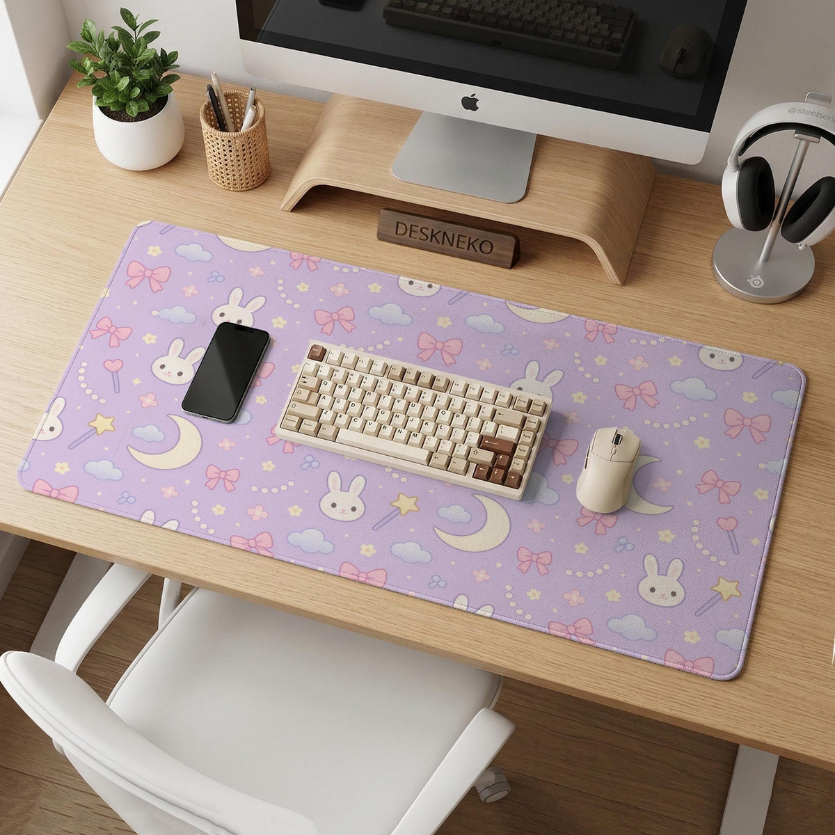 Pastel lavender desk mat with an all-over pattern of bunnies, crescent moons, clouds, bows, stars, and small flowers.