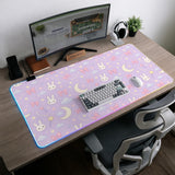 Lavender desk mat with an all-over pattern of bunny faces, clouds, moons, bows, and flowers in pastel colors.