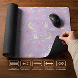 Pastel lavender desk mat with an all-over pattern of bunnies, crescent moons, clouds, bows, stars, and small flowers.