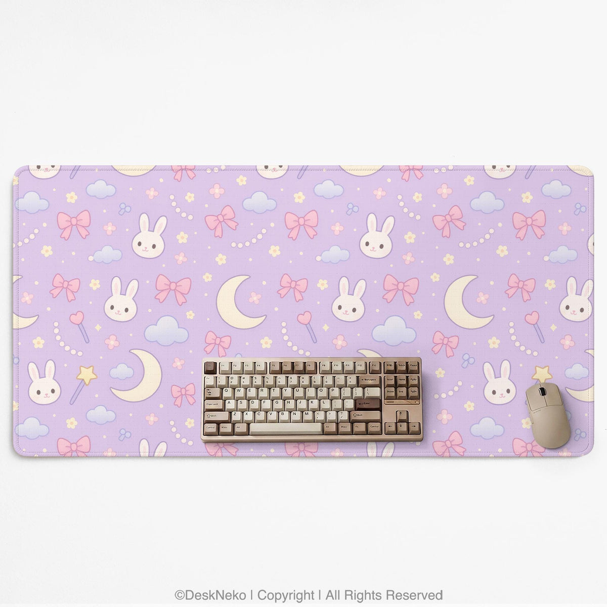 Pastel lavender desk mat with an all-over pattern of bunnies, crescent moons, clouds, bows, stars, and small flowers.