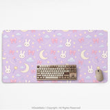 Pastel lavender desk mat with an all-over pattern of bunnies, crescent moons, clouds, bows, stars, and small flowers.