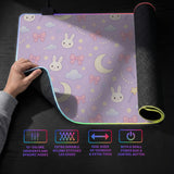 Pastel lavender desk mat with an all-over pattern of bunnies, crescent moons, clouds, bows, stars, and small flowers.