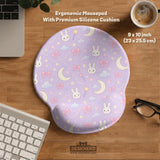 Pastel lavender desk mat with an all-over pattern of bunnies, crescent moons, clouds, bows, stars, and small flowers.