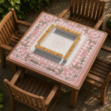 Square pink mahjong mat with a gingham border, floral corner details, and ribbon accents on a light background.