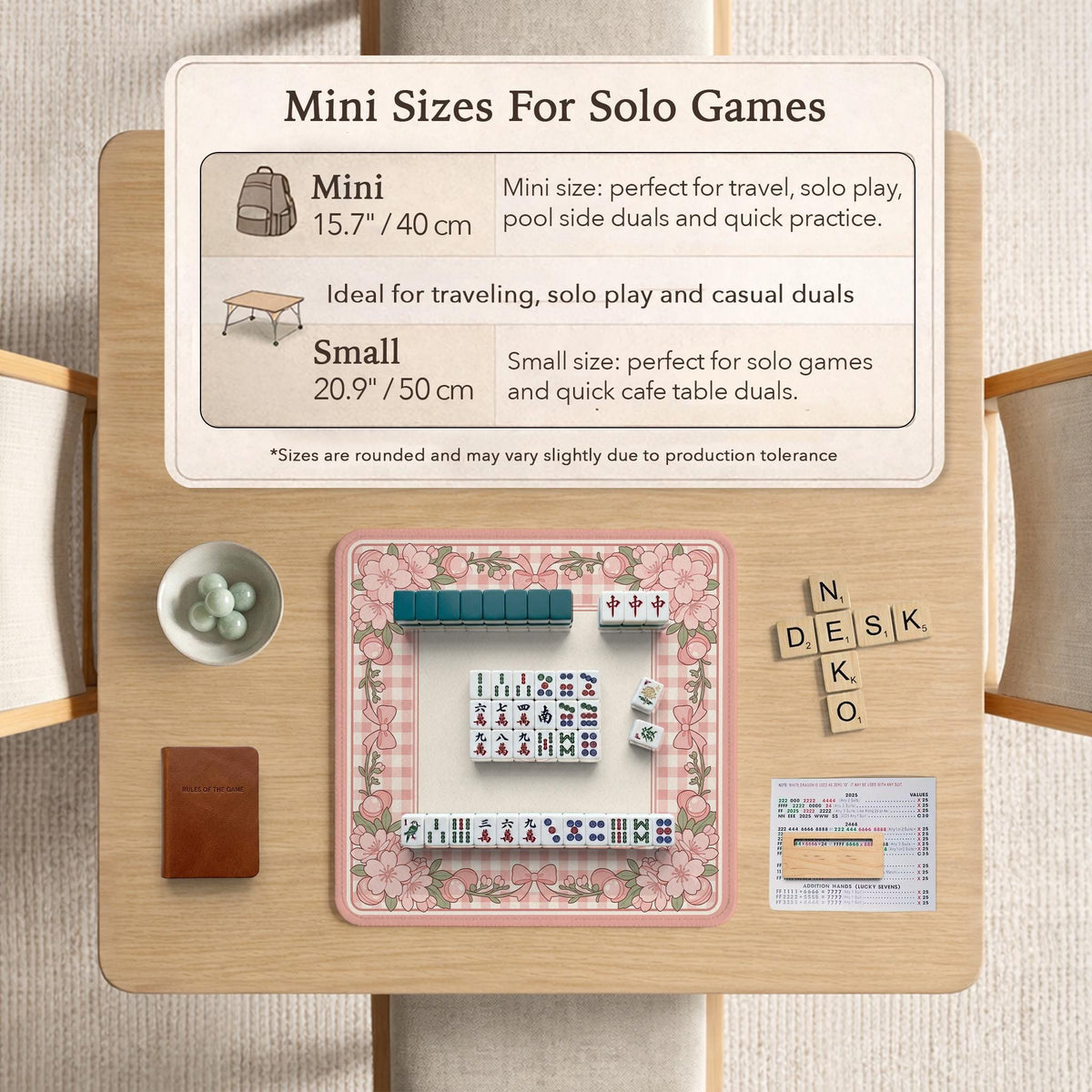 Pink gingham mahjong mat with a floral border, cherry blossom details, and a bow design around a plain center play area.