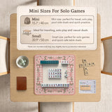 Pink gingham mahjong mat with a floral border, cherry blossom details, and a bow design around a plain center play area.