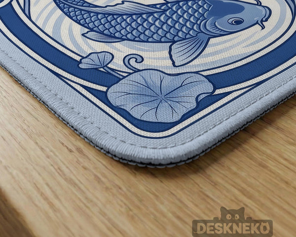 Blue and white square mahjong mat with a koi fish and lotus border design and a plain center area.