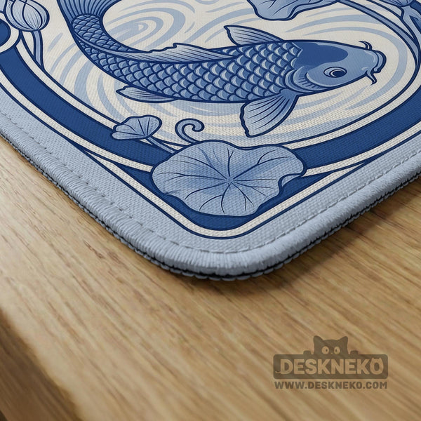 Navy blue square mahjong table mat with lotus flowers and koi fish in a porcelain-style border and a plain center.