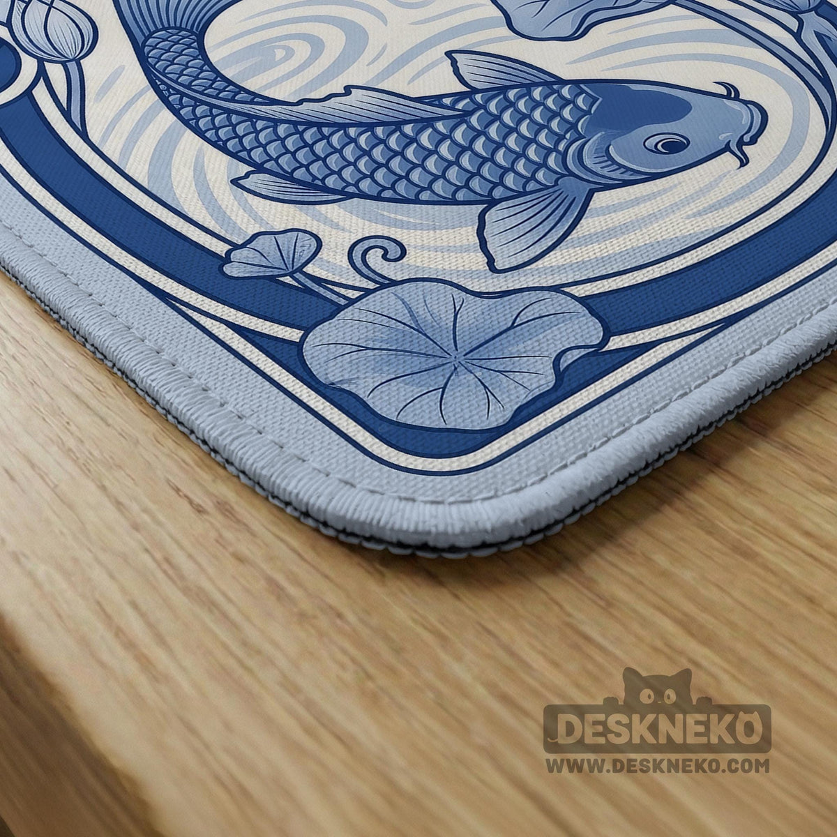 Navy blue square mahjong table mat with lotus flowers and koi fish in a porcelain-style border and a plain center.