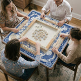 Blue and white square mahjong mat with a koi fish and lotus border design and a plain center area.