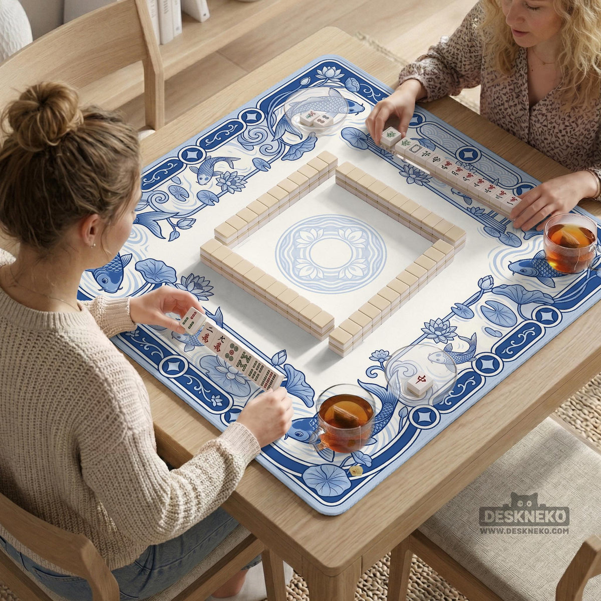 Navy blue square mahjong table mat with lotus flowers and koi fish in a porcelain-style border and a plain center.