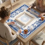 Navy blue square mahjong table mat with lotus flowers and koi fish in a porcelain-style border and a plain center.