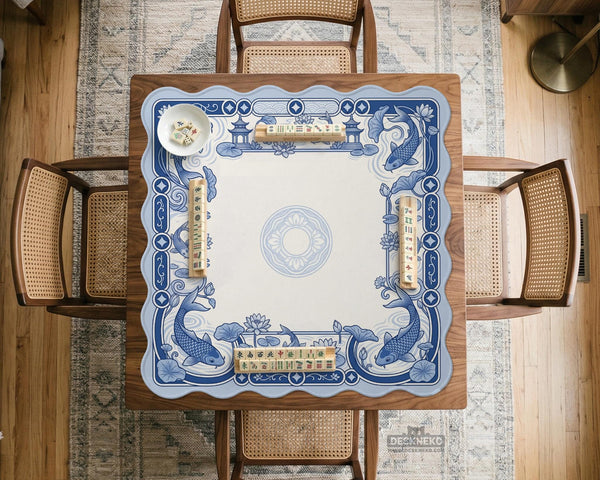 Blue and white square mahjong mat with a koi fish and lotus border design and a plain center area.