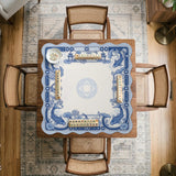 Navy blue square mahjong table mat with lotus flowers and koi fish in a porcelain-style border and a plain center.