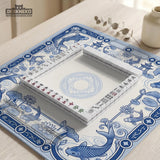 Navy blue square mahjong table mat with lotus flowers and koi fish in a porcelain-style border and a plain center.