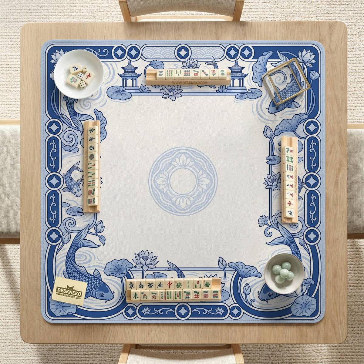 Navy blue square mahjong table mat with lotus flowers and koi fish in a porcelain-style border and a plain center.