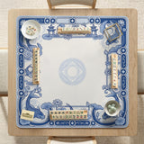 Navy blue square mahjong table mat with lotus flowers and koi fish in a porcelain-style border and a plain center.
