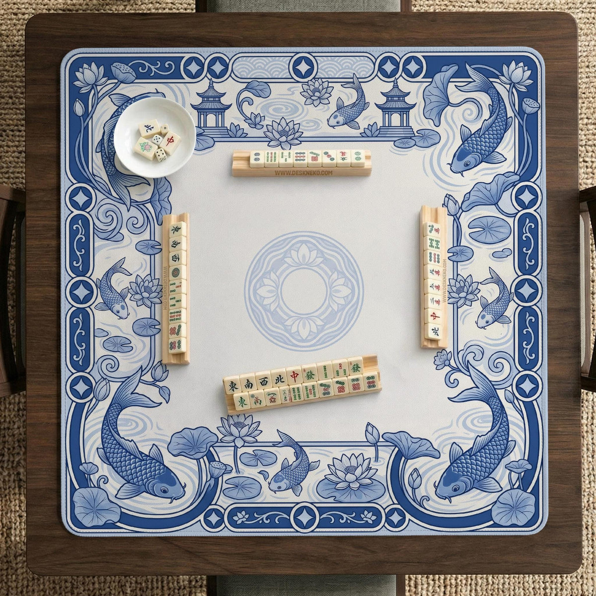 Blue and white square mahjong mat with a koi fish and lotus border design and a plain center area.