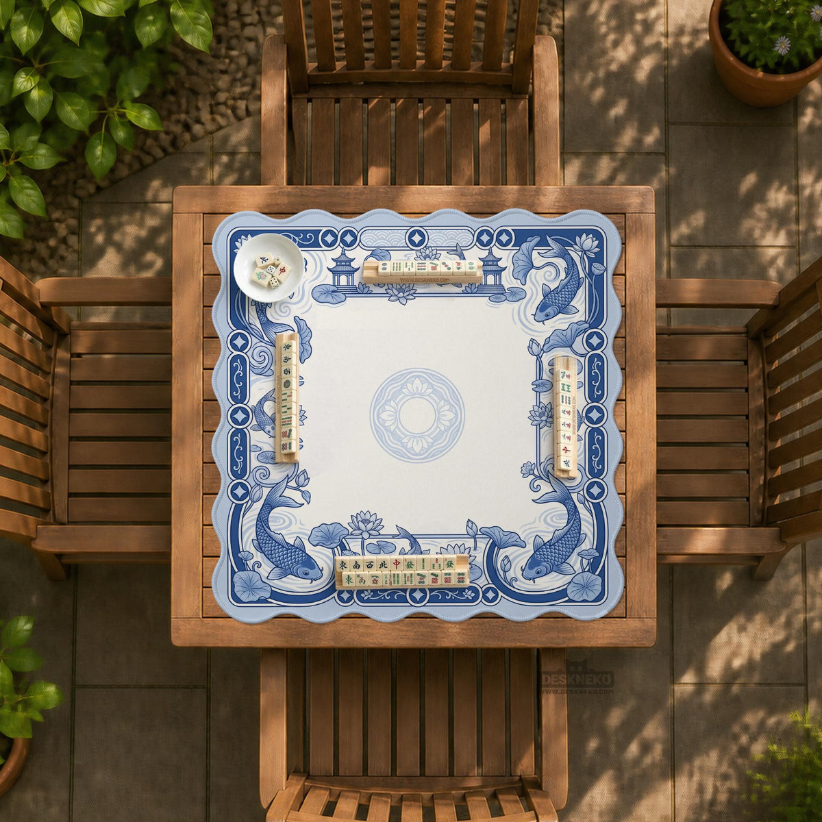 Blue and white square mahjong mat with a koi fish and lotus border design and a plain center area.