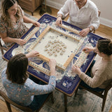 Blue mahjong table mat with a peacock and floral border, ivory center, lavender flowers, and scalloped edges.