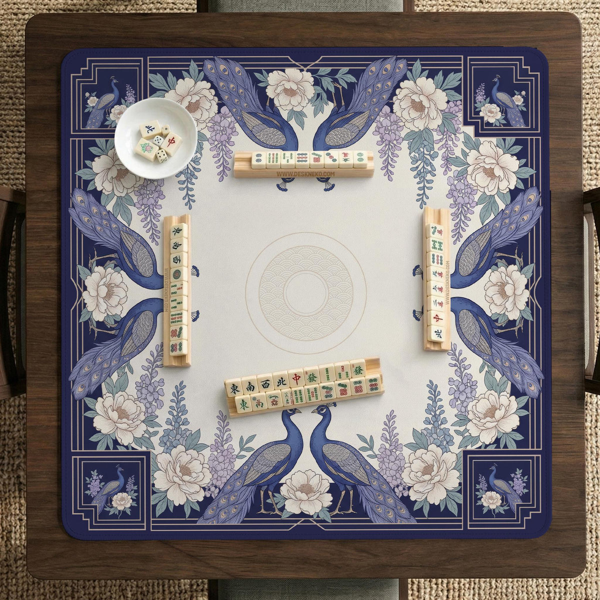 Blue mahjong table mat with a peacock and floral border, ivory center, lavender flowers, and scalloped edges.