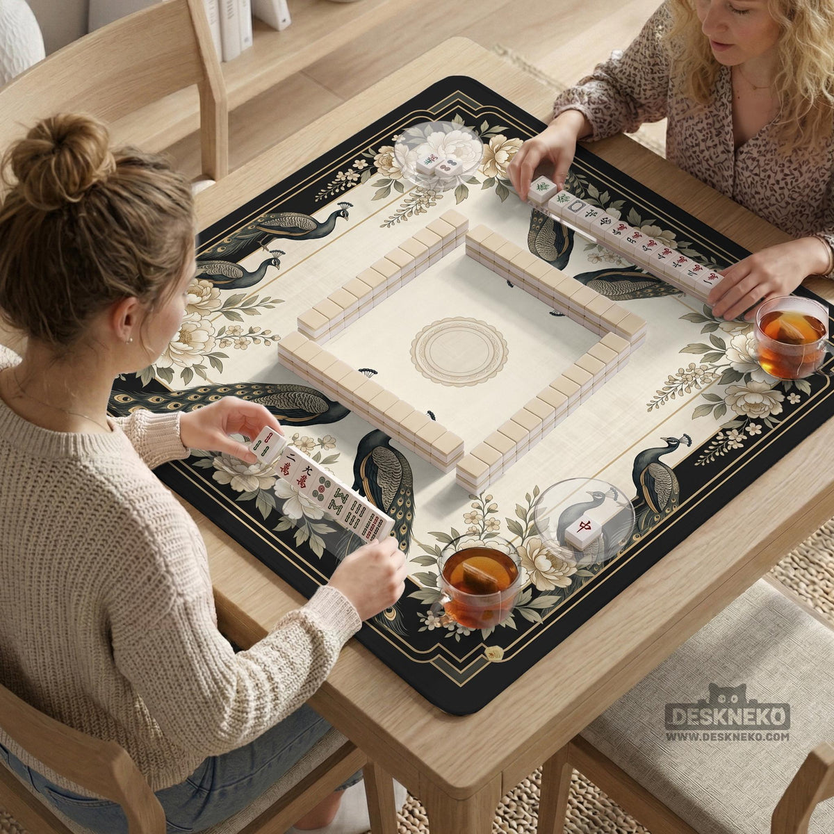 Square ivory mahjong mat with a black peacock border, cream flowers, and gold accent details.