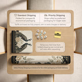 Square ivory mahjong mat with a black peacock border, cream flowers, and gold accent details.