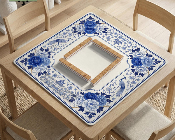 Square blue and white mahjong mat with peonies, cranes, pagoda accents, and chinoiserie linework around a plain center.